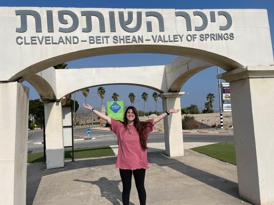 Partnership: Ellie Shafron in front of the Cleveland-Beit Shean partnership sign at a traffic circle in Beit Shean.
Submitted photo
